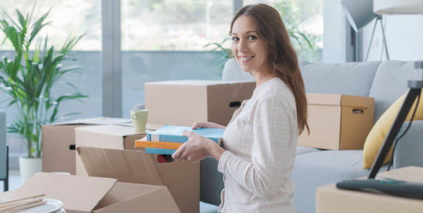 istock Woman unpacking in her new house 1319195936