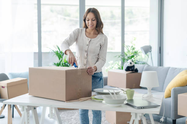 istock Woman unpacking in her new home 1319195975