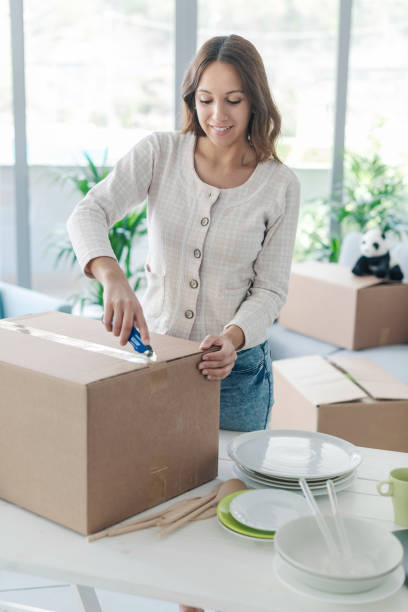 istock Woman unpacking in her new home 1319196820
