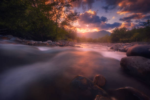 istock Beautiful sunny summer landscape. Fast flowing mountain river 1319198921