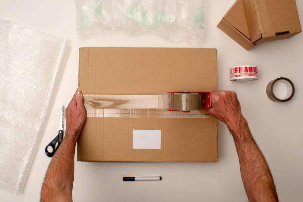Cardboard box, tape, bubble pack, scissors and marker pen.