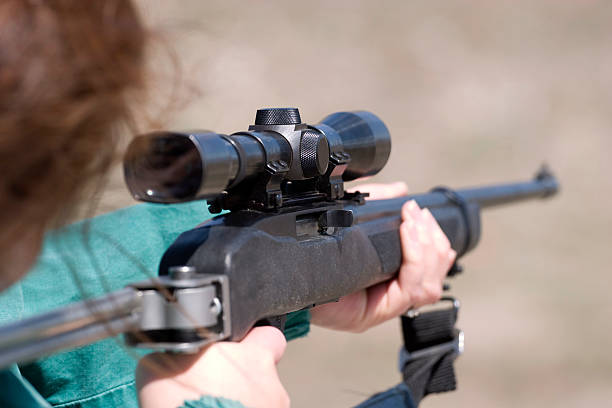 istock Woman shooting rifle 131920479