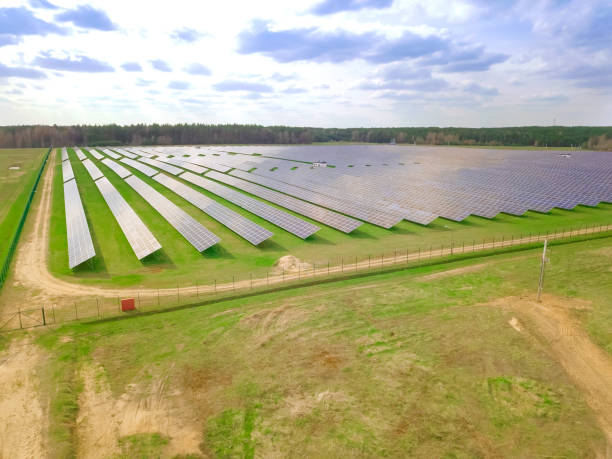 istock Drone view of a solar power plant on a sunny day with clouds. Solar panels from a drone. Source of ecological renewable energy 1319206684