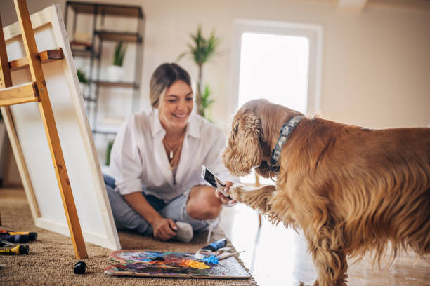 istock Female artist playing with dog 1319206727