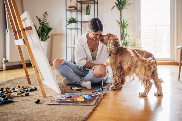 istock Female artist playing with dog 1319206756