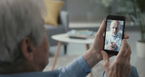 istock Senior man video calling his doctor 1319207731