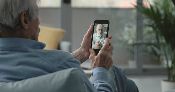 istock Elderly man video calling his doctor 1319207987