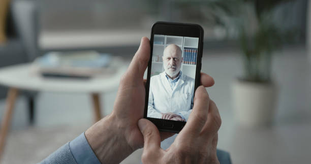 istock Elderly man video calling his doctor 1319208135