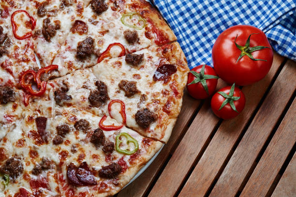 Tasty pizza with ingredients on rustic wooden table