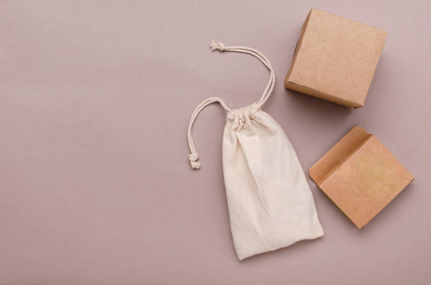 istock Top view of cloth bag, cardoard boxes for plastic free packaging on the brown surface.Empty space 1319213295