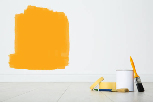 istock Set with decorator's tools and paint on floor near white wall 1319215292