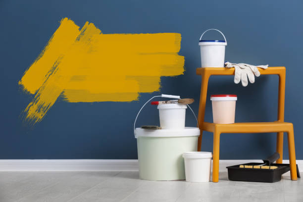 istock Set with decorator's tools and paint on floor near blue wall 1319215317
