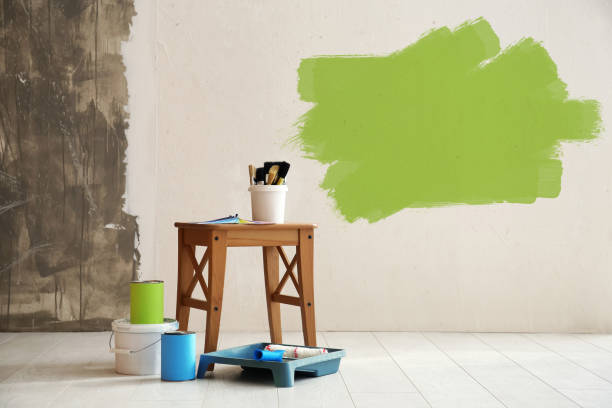 istock Set with decorator's tools and paint on floor near white wall 1319215320
