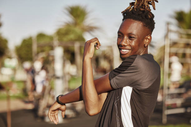 istock Shot of a young man stretching before a workout 1319216826