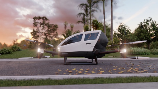 An air taxi in unmanned mode takes off and goes to its destination. View of an unmanned aerial passenger vehicle standing on the road.