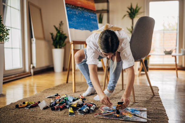 istock Beautiful woman painter mixing colors 1319224668