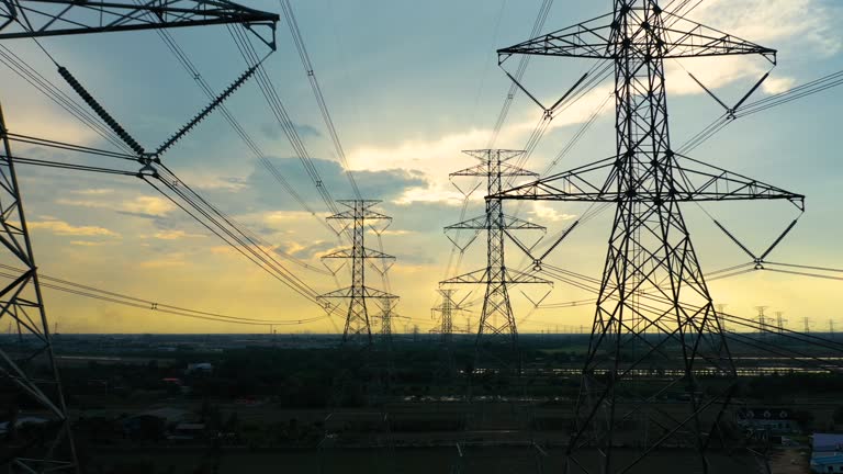 Dolly shot aerial view high voltage power pylons