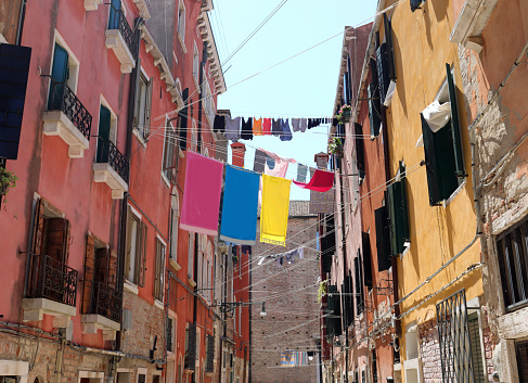 clothes hanging out to dry in a narrow Venice alley on a summer day