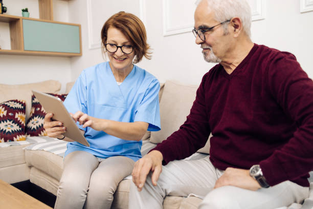 istock Mature doctor doing a home checkup to her senior patient 1319227931