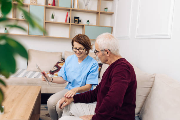 istock Mature doctor in a home visit supporting her patient 1319227954
