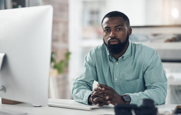 istock Shot of a handsome young businessman sitting alone in his office and using his computer 1319228895