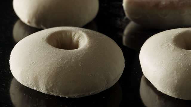 a group of plain bagels baking in time-lapse
