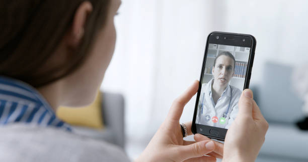 istock Woman video calling her online doctor 1319232625
