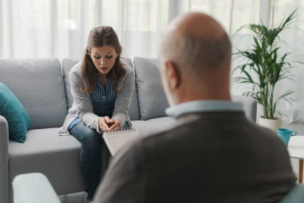 istock Depressed woman sitting on the therapist couch 1319232935