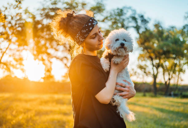 istock Young woman with a puppy in her hands 1319236743