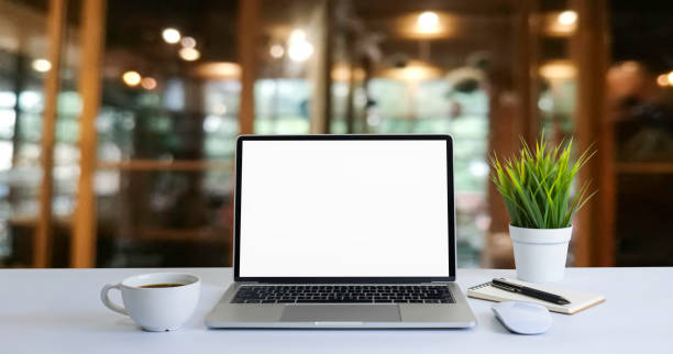 istock Front view of open laptop computer notebook with blank monitor white screen display on work table desk. Workspace office modern for job business online communication technology in shop or home indoor. 1319240266