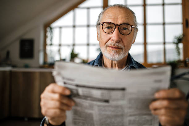 istock Senior man at home reading newspapers 1319241241