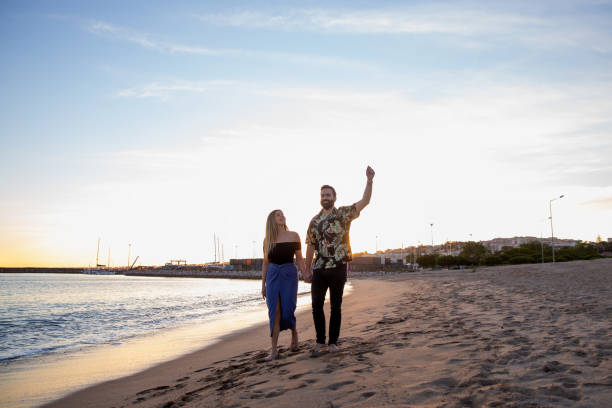 istock Couple enjoying the sunset at the beach 1319242980