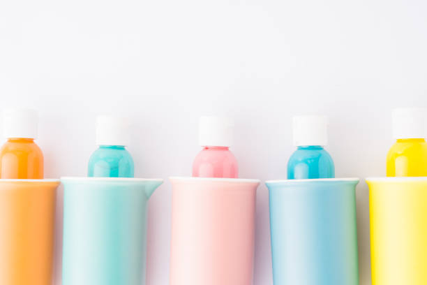 istock Colored bowl and jar, pantone, colored items diplayed on a white background, egg carrier, and different color paint on plastic container,   top view, flatlay, wallpaper type advertisement style. 1319243126