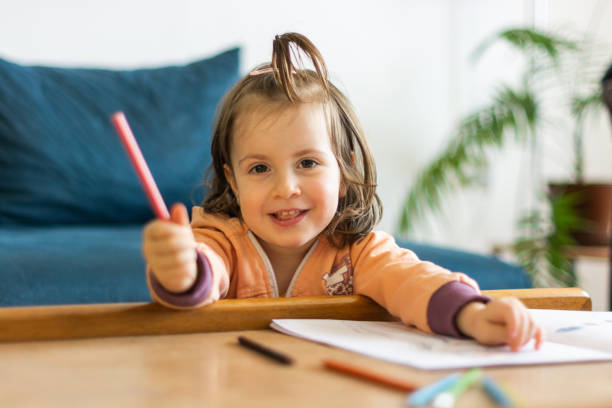 istock Girl drawing at home 1319243397