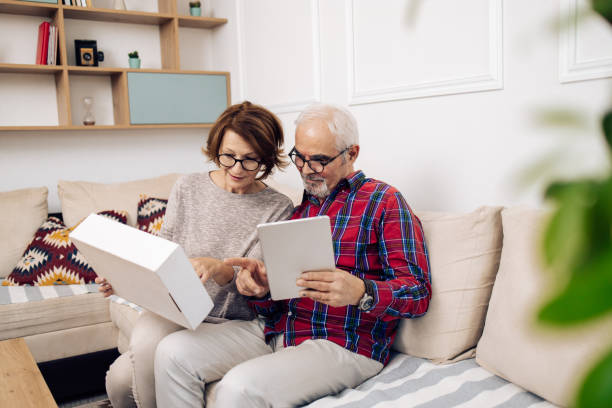 istock Senior couple using an online service for delivering packages 1319246023