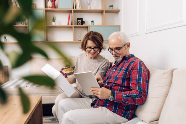 istock Happy senior couple sending a package using digital delivery service 1319246024
