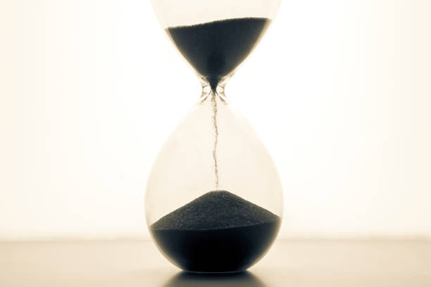 istock Hourglass on a light background. Time is money. Business solutions in time. 1319248918