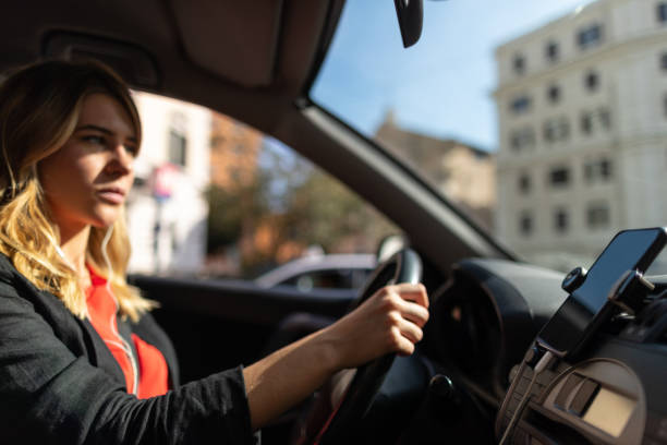 Business woman commuting, driving car in Rome Business woman commuting, driving car in Rome vehicle interior audio stock pictures, royalty-free photos & images