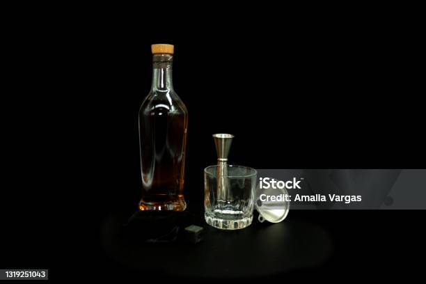 Old Fashon Glass Next To Bottle With Scotch Whiskey Stones Funnel