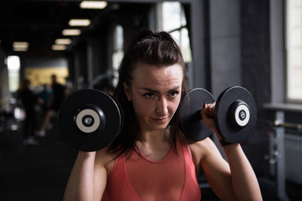 istock Sportswoman exercising at gym 1319253058