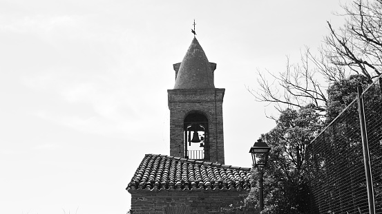 A bell tower of a medieval church in an Italian village (Marche, Italy, Europe)