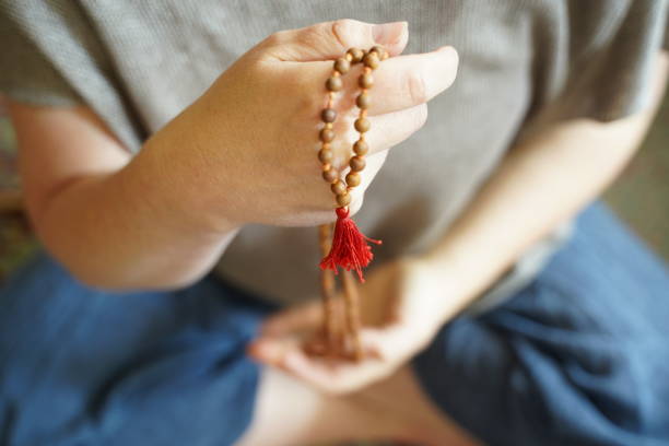Woman with a mala bead her hands stock photo