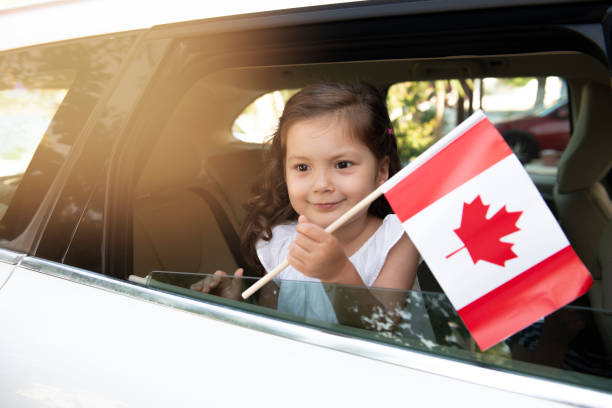istock Girl Holding Canadian Flag 1319255137