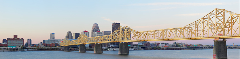 Panoramic view of the Clark memorial bridge  and the skyline of Louisville - at dawn - as seen from across the Ohio river.