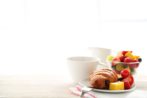 Breakfast items on the table by the window