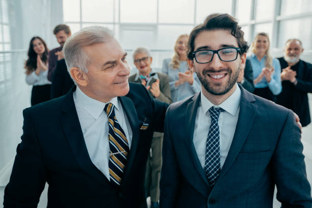 istock close up. happy business partners standing together 1319258080