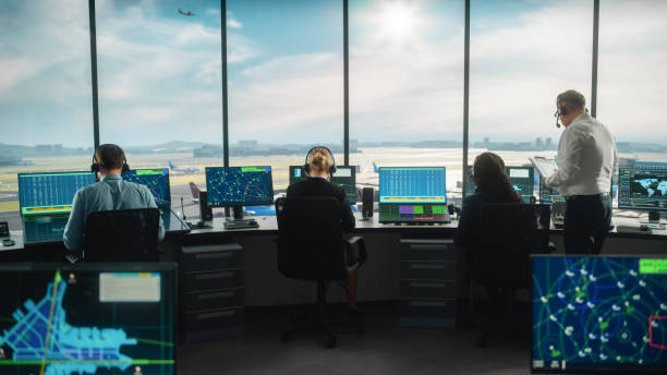 istock Diverse Air Traffic Control Team Working in a Modern Airport Tower. Office Room is Full of Desktop Computer Displays with Navigation Screens, Airplane Departure and Arrival Data for Controllers. 1319258345