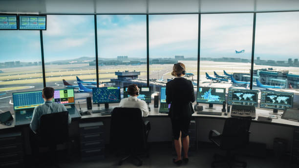 Diverse Air Traffic Control Team Working in a Modern Airport Tower. Office Room is Full of Desktop Computer Displays with Navigation Screens, Airplane Flight Radar Data for Controllers. Diverse Air Traffic Control Team Working in a Modern Airport Tower. Office Room is Full of Desktop Computer Displays with Navigation Screens, Airplane Flight Radar Data for Controllers. atc stock pictures, royalty-free photos & images