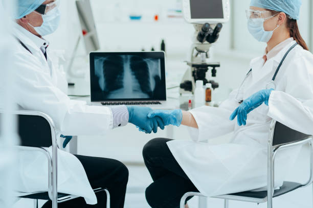 istock close up. medical colleagues shaking hands with each other 1319258509