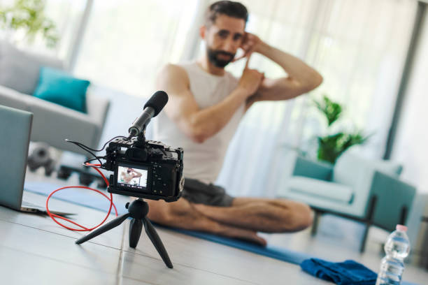 istock Professional vlogger recording a workout video 1319259091